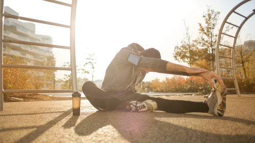 runner stretching to relieve lower back ache